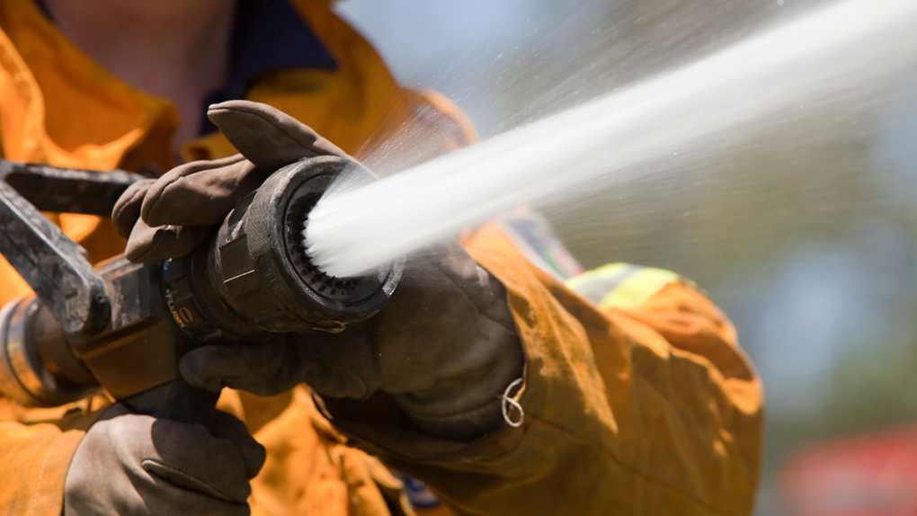 Firefighter with water hose