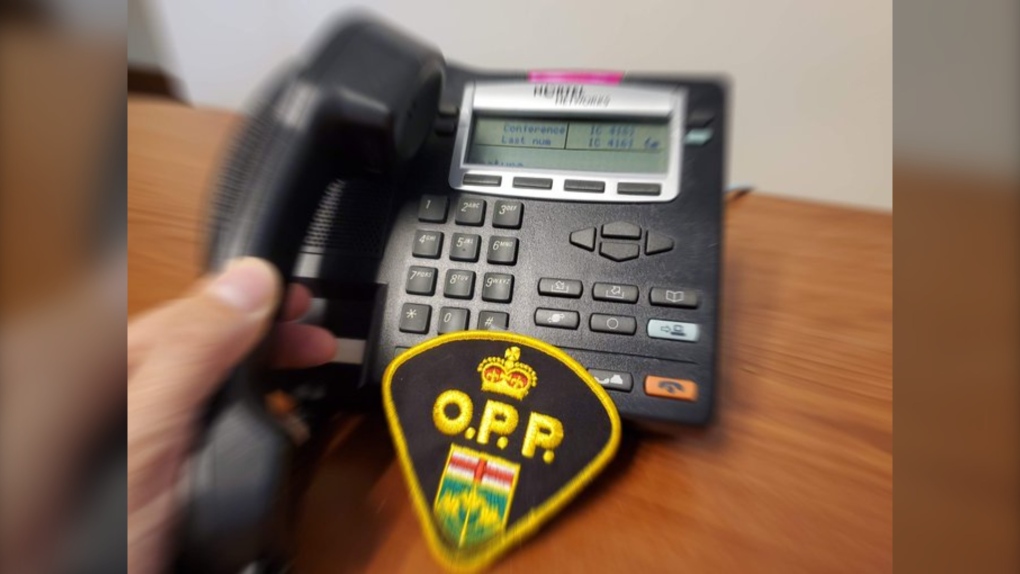 A photo of a person picking up a telephone with the OPP crest overlaid on the image. (Source: OPP West Region)