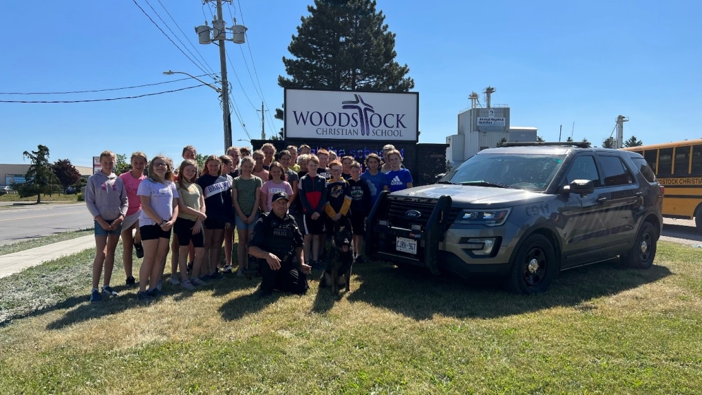 PSD Taz and the Woodstock Christian School's grade six class who picked his name. (Courtesy Woodstock Police Service)
