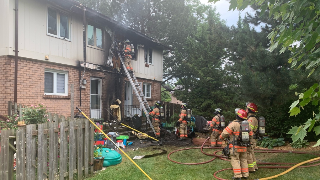Fire crews were on scene of a townhouse fire at 555 Lawson Road in London, Ont. on Sunday, June 26, 2022. (Brent Lale/CTV News London)