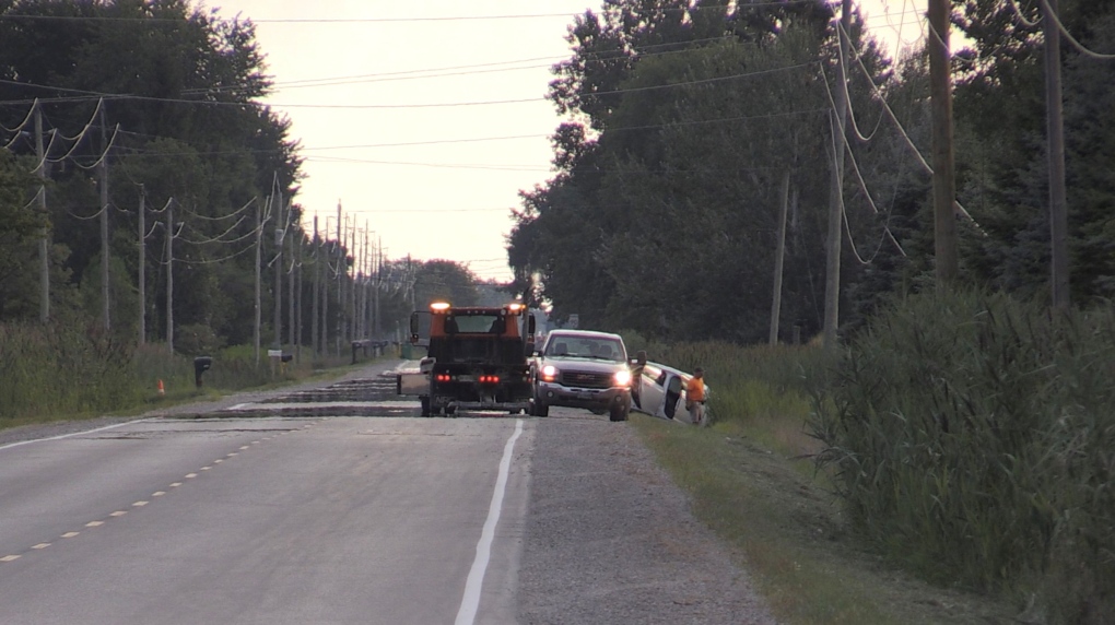 A car is seen in a ditch in the area of Glendon Drive near Springfield Road in Southwest Middlesex, Ont. on the evening of August 15, 2022. Hydro One says a car accident knocked out power for 3,000 residents. (Daryl Newcombe/CTV News London)