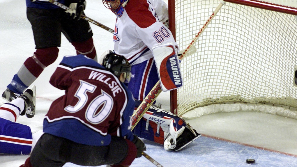 Colorado Avalanche Brian Willsie can't get to a loose puck in the crease as Montreal Canadiens goaltender Jose Theodore looks on during first period NHL action in Montreal Tuesday Nov. 6, 2001.(CP PHOTO/Ryan Remiorz)