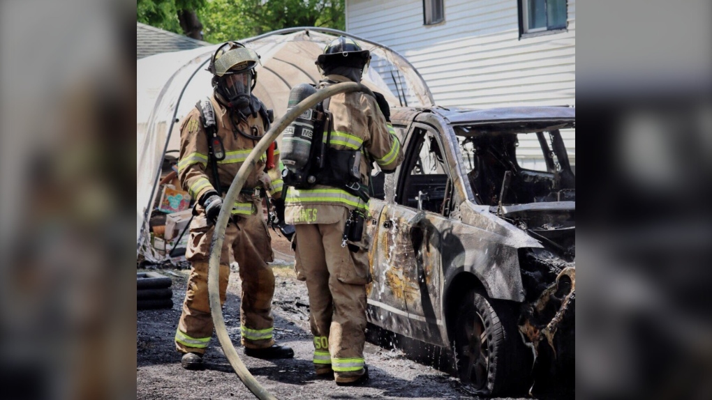 Sarnia fire crews work to stop a vehicle fire before it spreads to nearby homes. June 7, 2023. (Source: Sarnia Fire Rescue)