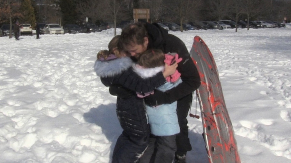 dad hugging daughters